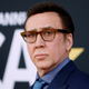 Nicolas Cage wears a blue suit and brown eyeglasses at a recent red-carpet event.